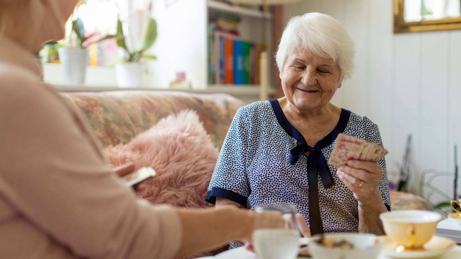 Frauen kartenspielend auf dem Sofa